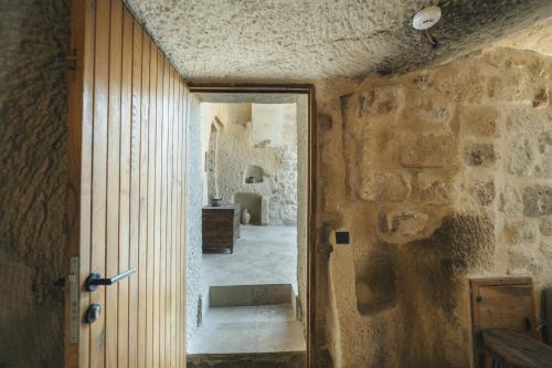a doorway to a room with a stone wall at Vie Cappadocia - Adults Only in Nevsehir