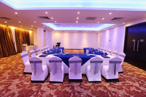 a banquet hall with a table and chairs in a room at Best Western Elyon Colombo in Colombo
