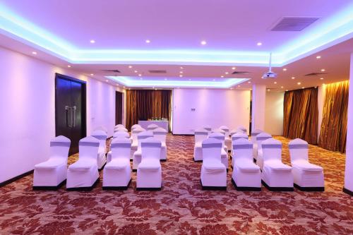 a room with rows of white chairs and a stage at Best Western Elyon Colombo in Colombo