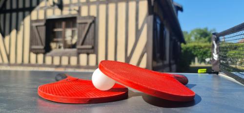 un paio di scarpe rosse, sedute sopra un tavolo di Maison Évasion Normande a Sainte-Opportune-la-Mare