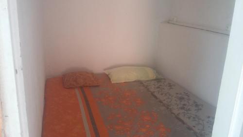 a small room with a bed in a corner at Kenet and Sun in Morne-à-lʼEau