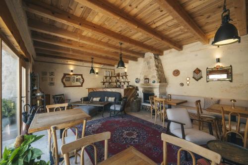 a restaurant with tables and chairs in a room at Vie Cappadocia - Adults Only in Nevsehir