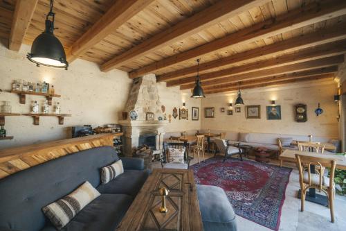 a living room with a blue couch and a fireplace at Vie Cappadocia - Adults Only in Nevsehir