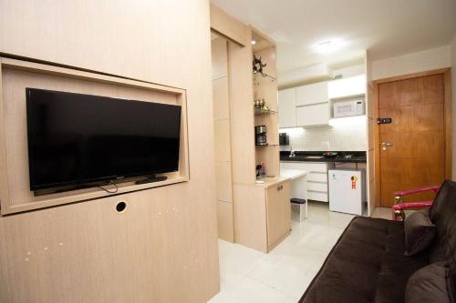 a living room with a flat screen tv on a wall at OZPED Flats Particulares Edifício Life Resort in Brasilia