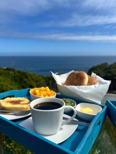a blue tray with breakfast foods and a cup of coffee at Tunquen Magico in Tunquen
