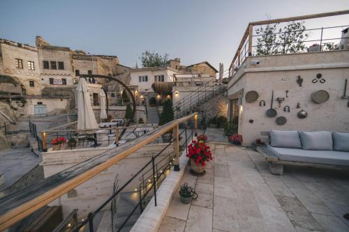 a rooftop patio with a couch and a couch at Vie Cappadocia - Adults Only in Nevsehir