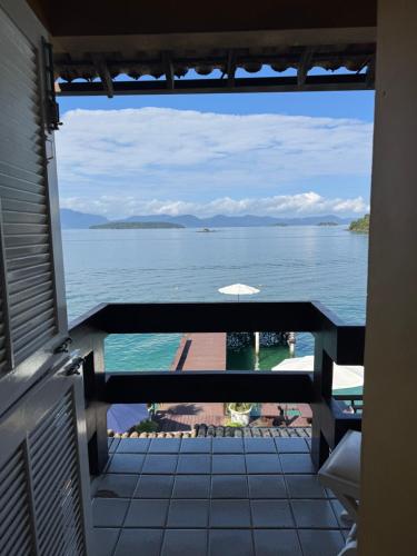 a view of the ocean from the balcony of a house at Pousada Casa do Bicho Preguiça in Angra dos Reis
