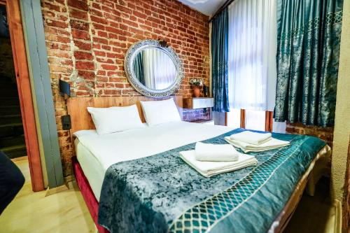 Ένα ή περισσότερα κρεβάτια σε δωμάτιο στο Squit Suits Hotel