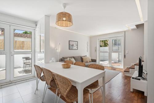 a kitchen and living room with a white table and chairs at GuestReady - Fantastic family home in Salgueiros in Porto