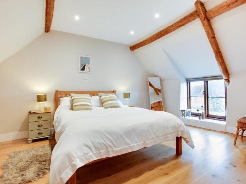 a bedroom with a large bed with white sheets and pillows at 3 Bed in Niton 93697 in Niton