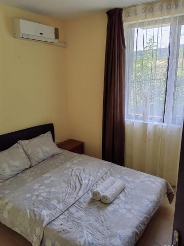 a bedroom with a bed with a towel on it at Apartament Morela in Sunny Beach