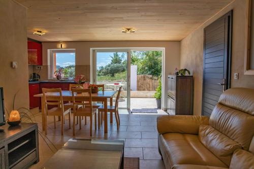 a living room with a couch and a table at Gîte Centre Santé Bien-être Naturéconnaissance in Usclas-du-Bosc