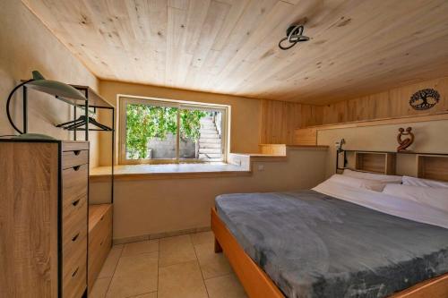 a bedroom with a large bed and a window at Gîte Centre Santé Bien-être Naturéconnaissance in Usclas-du-Bosc