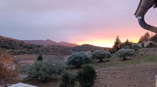 a view of a hill with trees and a sunset at Gîte Centre Santé Bien-être Naturéconnaissance in Usclas-du-Bosc