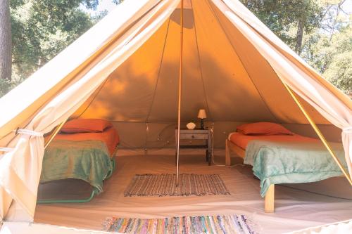 a tent with two beds in a room at Le Spot Saint-Trojan in Saint-Trojan-les-Bains