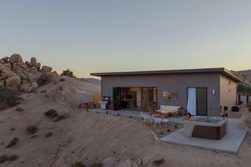 a small house in the middle of a desert at Fox Inn Epic Views, Hot Tub, Cowboy Tub, Grill in Yucca Valley