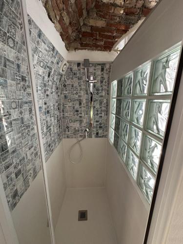 a bathroom with a shower with a glass door at Ellie in Imperia