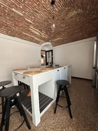 a kitchen with a sink and two stools at Ellie in Imperia