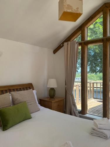 a bedroom with a bed and a large window at Stable lodge 2 Bedrooms in Horspath