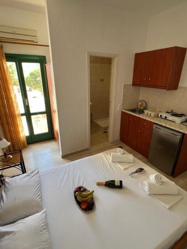 a large white bed in a kitchen with fruit on it at Santa Magia in Kamari