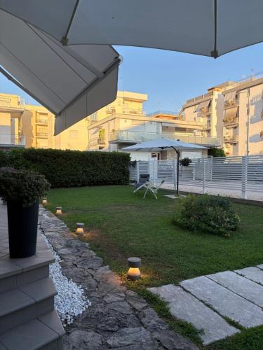 a backyard with a stone pathway and an umbrella at Casa Mar - B&B - in Terracina