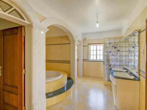 a large bathroom with a tub and a sink at Wonderful 6 Bedroom Villa Casa Santa Isabel Private Pool Ferragudo in Parchal