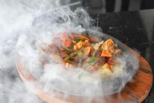 a plate of food engulfed in smoke on a table at Best Western Elyon Colombo in Colombo