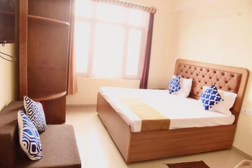 a bedroom with a large bed with a window at The Boho BnB Near Mall in Shimla