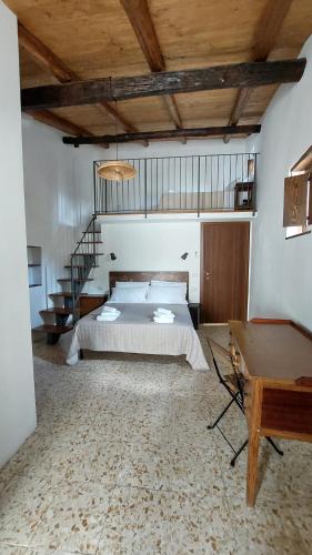 a large bedroom with a bed and a staircase at Selice 9 B&B in Casaletto Spartano