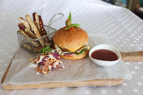 a sandwich and french fries and a bowl of ketchup at Best Western Elyon Colombo in Colombo
