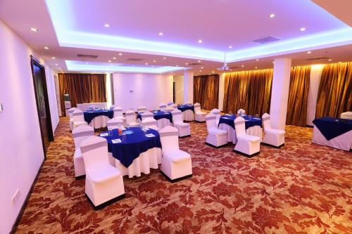 a banquet hall with blue and white tables and chairs at Best Western Elyon Colombo in Colombo