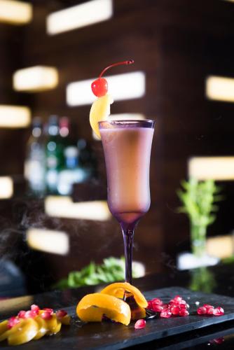 a drink with a cherry on top of a table at Best Western Elyon Colombo in Colombo