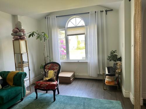 a living room with a green couch and a window at 3-Bedroom Modern House in Halifax