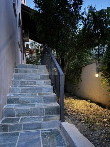 a set of stairs leading up to a house at Lyria Hotel Apartments in Stalos