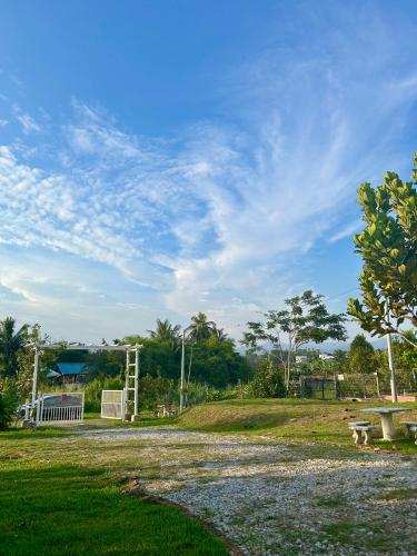 a park with a picnic table and a bench at Amicasa Homestay Seremban in Seremban