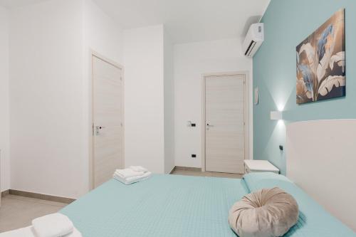 a bedroom with a blue bed with a pillow on it at Bed And Breakfast Champagneria in Castelvetrano Selinunte