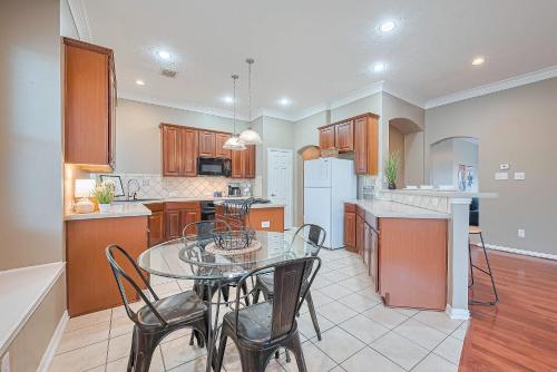 a kitchen with a glass table and chairs in it at Peaceful Exec Home w Office Near Everything in Conroe