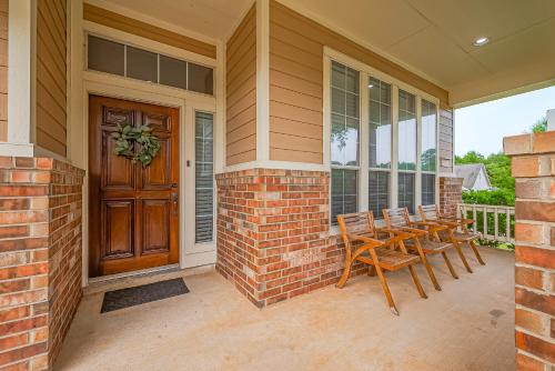 a porch with chairs and a wooden door at Peaceful Exec Home w Office Near Everything in Conroe