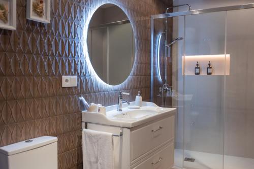 a bathroom with a sink and a mirror and a shower at La casa del huerto in Caravaca de la Cruz