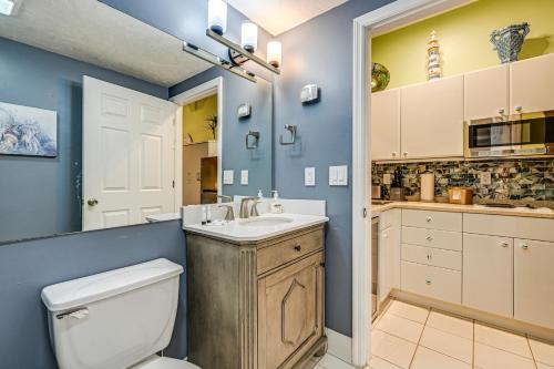 a bathroom with a toilet and a sink at Poolside Relaxation Resort Condo in Naples! in Naples