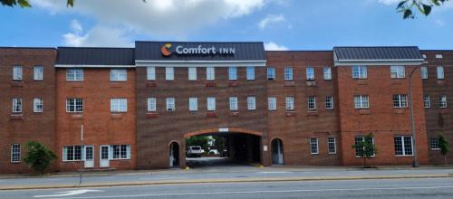 a large red brick building with a tunnel at Comfort Inn Ballston in Arlington