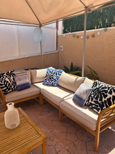 a room with two couches sitting under a tent at Casa Bellevue in Gran Alacant