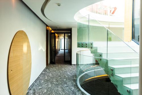 a hallway with a glass staircase in a building at Riviera Blue Hotel in Sunny Beach