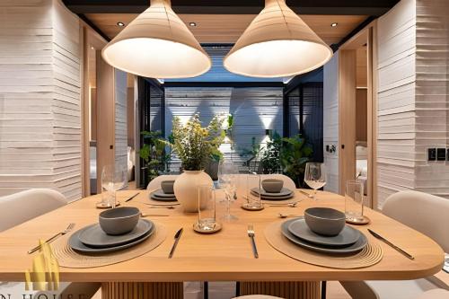 a dining room with a table with chairs and lights at Casa Biflora - Natural luxury in top location in El Poblado