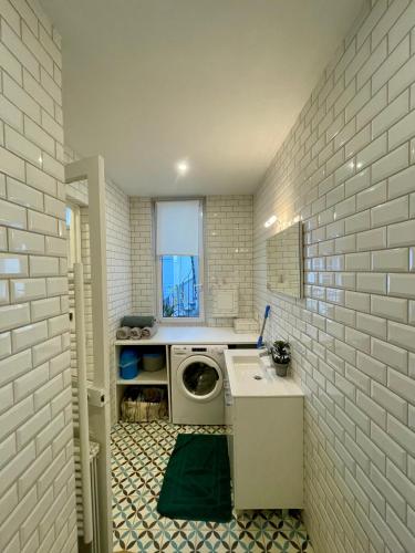 une buanderie avec une machine à laver et un lave-linge dans l'établissement Appartement Raspail St germain Paris, à Paris