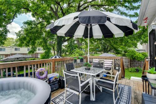 a patio with a table and chairs and an umbrella at Outdoor Pool and Hot Tub Retreat - 6 Mi to Dtwn! in Baltimore