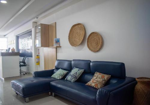 a blue couch sitting in a living room at Hotel Aguamarina in Santa Marta