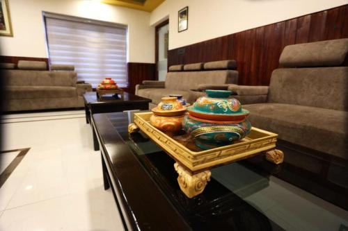 a living room with a table with two vases on it at The Nalanda Boho in Leh
