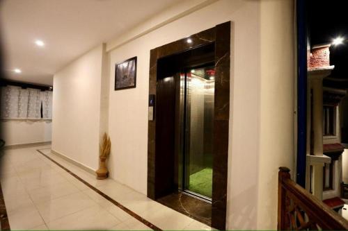 a hallway with a glass door in a house at The Nalanda Boho in Leh