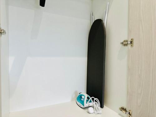 a pair of flip flops sitting next to a surfboard at Explore Penang Stay Style w Sky pool Sea airport 9pax in Bayan Lepas